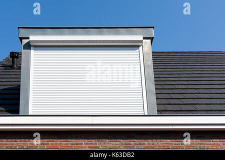 Dormer window with rolling safety  shutter in the Netherlands Stock Photo
