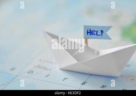 Immigration and ask for asylum concept - paper boat on a map Stock Photo