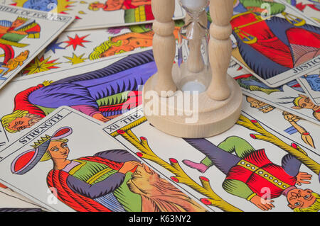 Hourglass over tarot cards. Esoteric themes Stock Photo
