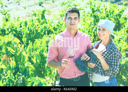 Two farmers posing with wine and grape at summertime Stock Photo
