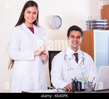Portrait of two positive therapeutists with stethoscope in private clinic Stock Photo