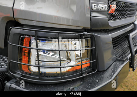 HYVINKAA, FINLAND - SEPTEMBER 8, 2017: Detail of headlamp protection on the new Scania XT truck front in rain. Scania Suomi Oy presents the new XT hea Stock Photo