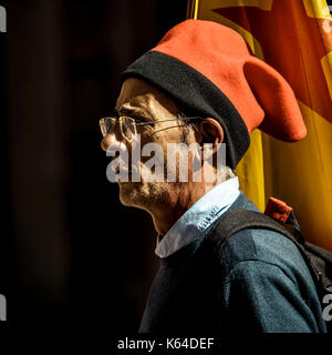 Barcelona, Spain. 11th Sep, 2017. A pro-independence activist wearing a red 'barretina' and an 'Estelada' flag is seen on the 'Diada' (Catalan National Day) in Barcelona Credit: Matthias Oesterle/Alamy Live News Stock Photo