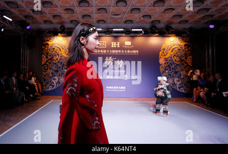 London, UK. 11th Sep, 2017. A seamstress and a model perform during the 'weaving a dream' fashion show celebrating the 45th anniversary of the establishment of the ambassadorial diplomatic relations between China and Britain in London Sept. 11, 2017. Credit: Han Yan/Xinhua/Alamy Live News Stock Photo