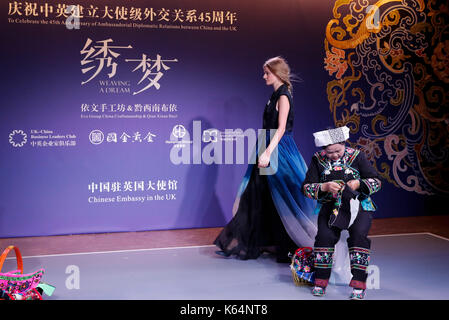 London, UK. 11th Sep, 2017. A seamstress and a model perform during the 'weaving a dream' fashion show celebrating the 45th anniversary of the establishment of the ambassadorial diplomatic relations between China and Britain in London Sept. 11, 2017. Credit: Han Yan/Xinhua/Alamy Live News Stock Photo
