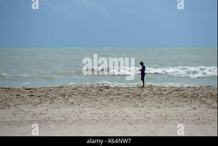 Miami, USA. 11th Sep, 2017. A man stands at a beach after Hurricane Irma swept through the area, in Miami, Florida, the United States, on Sept. 11, 2017. Powerful Hurricane Irma roared into Florida and knocked out power to more than 3 million homes and businesses in Florida on Sunday. Credit: Yin Bogu/Xinhua/Alamy Live News Stock Photo