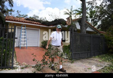 Miami, USA. 11th Sep, 2017. A man clears debris after Hurricane Irma swept through the area, in Miami, Florida, the United States, on Sept. 11, 2017. Powerful Hurricane Irma roared into Florida and knocked out power to more than 3 million homes and businesses in Florida on Sunday. Credit: Yin Bogu/Xinhua/Alamy Live News Stock Photo