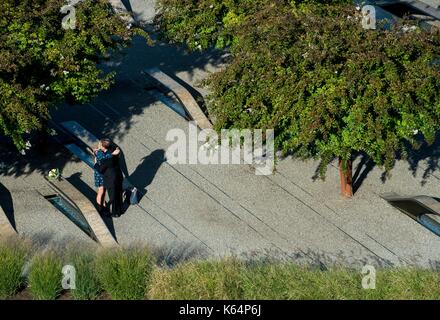 Arlington, United States Of America. 11th Sep, 2017. Family members who lost loved ones during the 9/11 attack on the Pentagon embrace in the memorial garden prior to a ceremony commemorating the anniversary September 11, 2017 in Arlington, Virginia. Credit: Planetpix/Alamy Live News Stock Photo