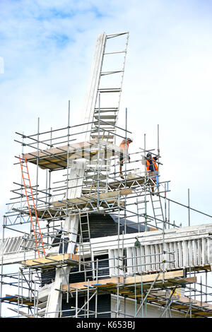 Mountnessing Windmill post mill listed building with scaffolding & workers repairing decaying and rotting woodwork on sails Brentwood Essex England UK Stock Photo