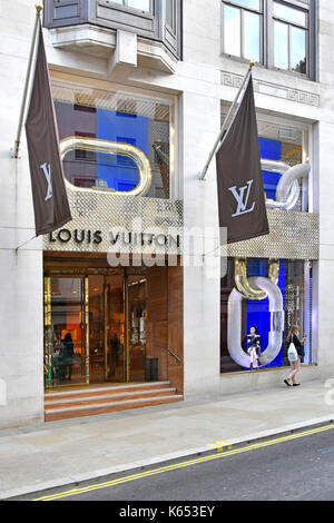 Louis Vuitton shop window display of luxury goods at their Mayfair premises in New Bond Street in the West End of London England UK