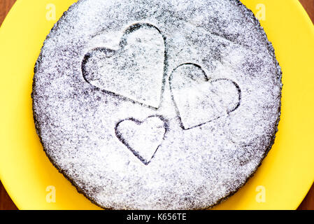 Cocoa cake with velvety sugar hearts Stock Photo