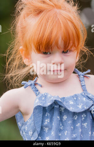 A MODEL RELEASED 2 year old girl with ginger hair outdoors in the Uk Stock Photo