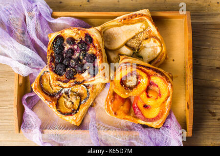Baked fruit sweet pie slices on a tray Stock Photo
