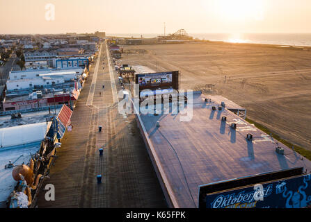WILDWOOD, NEW JERSEY, USA - SEPTEMBER 5, 2017: Empty Wildwood boardwalk and beach at sunrise, shoot with a drone. Wildwood in a tourist resort city on Stock Photo