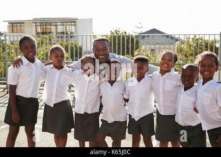 Teacher and elementary school kids in playground, portrait Stock Photo