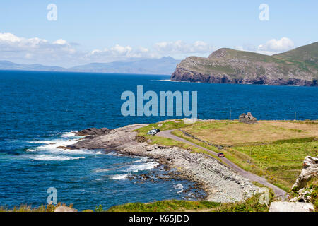 Landscape shot of the coast line at Cromwell Point,Valentia Island, Ring of Kerry, Ireland on a bright sunny day against a blue sky with cirrus clouds Stock Photo