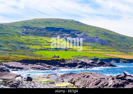 Landscape shot of the coast line at Cromwell Point,Valentia Island, Ring of Kerry, Ireland on a bright sunny day against a blue sky with cirrus clouds Stock Photo