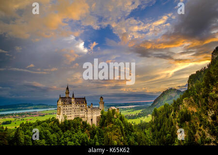 Neuschwanstein Castle at sunrise, seen from the bridge Marienbrücke, built high above the Pöllat Gorge Stock Photo