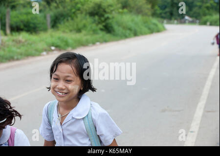 Burmese migrant children walk home from school near the dump site in the outskirts of Mae Sot, Thailand. Stock Photo