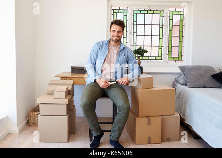 Portrait Of Man In Bedroom Running Business From Home Stock Photo