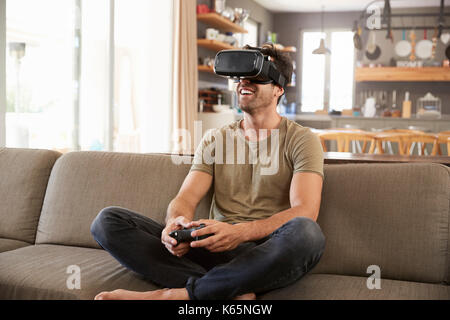 Man Playing Computer Game Wearing Virtual Reality Headset Stock Photo