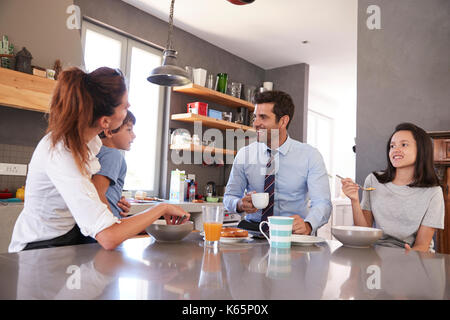 Father Having Family Breakfast In Kitchen Before Leaving For Work Stock Photo