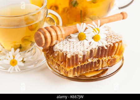 Honeycomb and chamomile tea on white Stock Photo