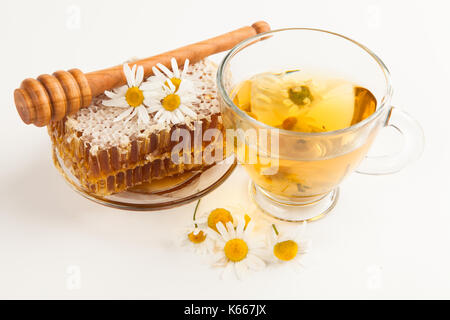 Honeycomb and chamomile tea on white Stock Photo