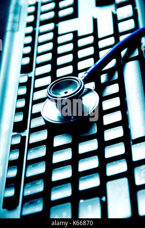 Blue stethoscope on computer keyboard on white table background. Online ...