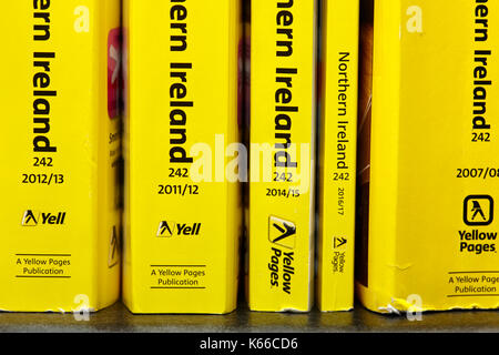 decreasing size later smaller thinner versions of the yellow pages classified telephone directory paper edition uk Stock Photo