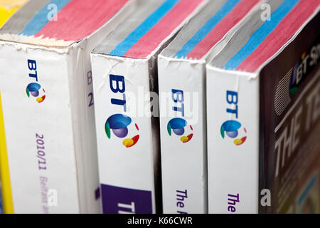 decreasing size versions of the BT local telephone directory paper edition Stock Photo