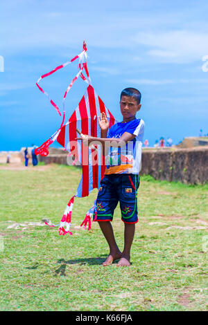 Little boy with colorful kite on the field at Galle Dutch fort Stock Photo