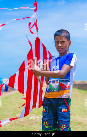 Little boy with colorful kite on the field at Galle Dutch fort Stock Photo