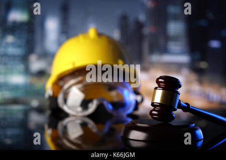 Law theme. Construction law's symbols  - helmet and gavel. Stock Photo