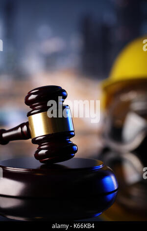 Law theme. Construction law's symbols  - helmet and gavel. Stock Photo