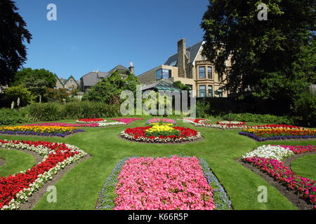 Victorian plant beds featuring marigolds and begonias in the Victorian Garden at Sheffield Botanical Gardens, Sheffield, Yorkshire,England,UK - summer Stock Photo