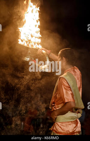 VARANASI, INDIA - CIRCA NOVEMBER 2016:  Young pandit performing the Ganga Aarti ceremony at the  Dasaswamedh Ghat in Varanasi. The Aarti is a powerful Stock Photo