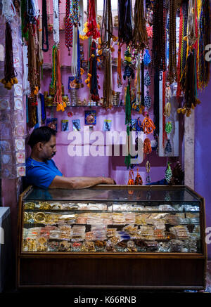 VARANASI, INDIA - CIRCA NOVEMBER 2016: Merchant in the streets of Old Varanasi. Stock Photo