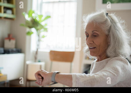 Older woman checking wristwatch Stock Photo