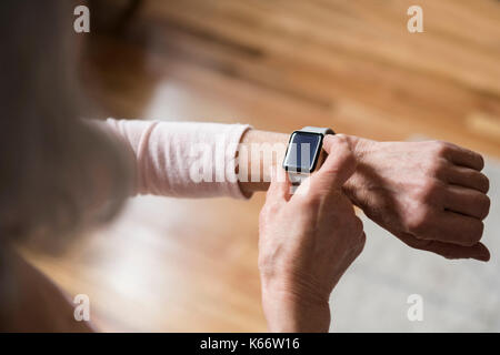 Older woman checking smart watch Stock Photo