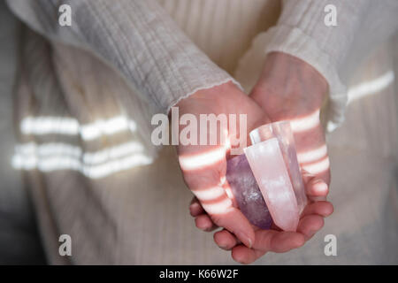 Hands of Caucasian woman holding crystals Stock Photo