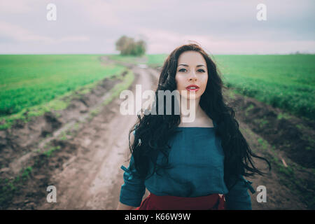 Caucasian woman standing on dirt path Stock Photo