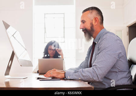 Man using computer desk Stock Photo