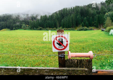 Electric wire with sign saying 'stop' Stock Photo