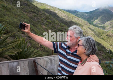 Older Caucasian couples posing for cell phone selfie Stock Photo