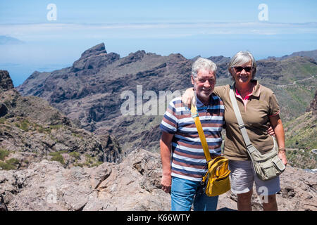 Portrait of smiling older Caucasian couple on mountain Stock Photo