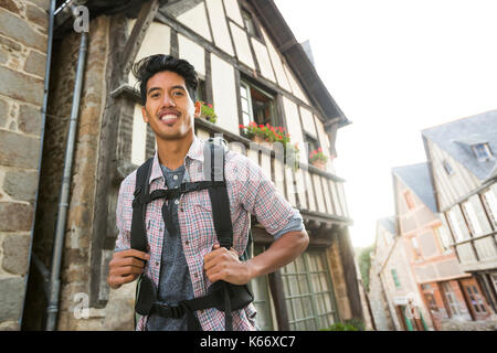 Asian man backpacking in city Stock Photo