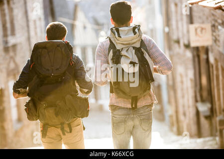 Men backpacking in city Stock Photo