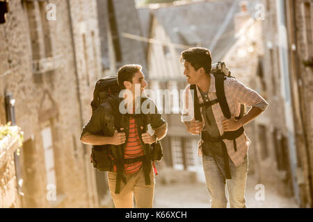 Men backpacking in city Stock Photo