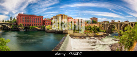 Panoramic cityscape view of Washington Water Power building and the Monroe Street Bridge along the Spokane river Stock Photo